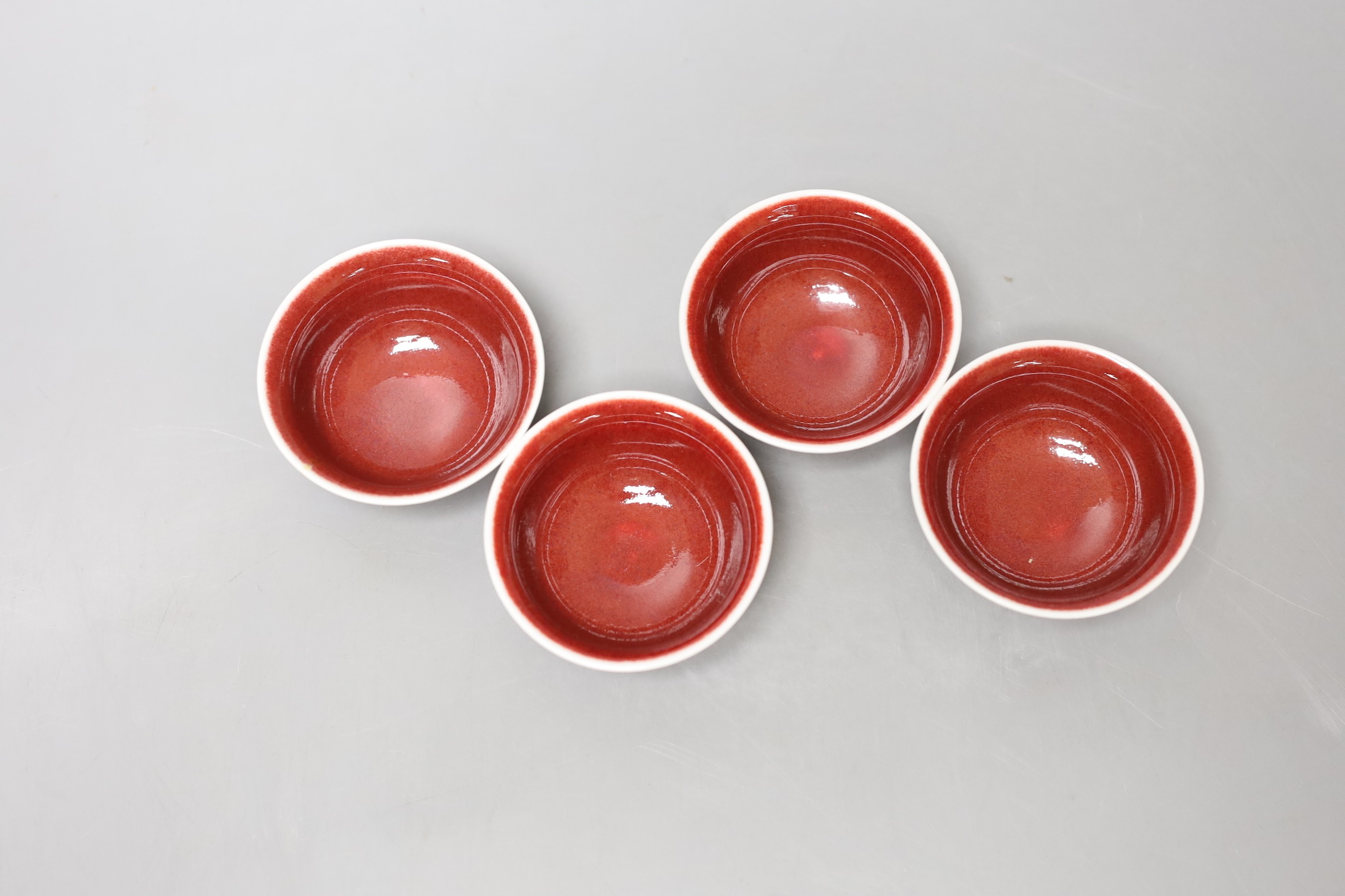 A set of four Chinese ox blood bowls, marks to base, 3.5cm high